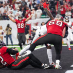 Sep 15, 2025; Houston, Texas, USA; Tampa Bay Buccaneers wide receiver Emeka Egbuka (2) rushes for a touchdown during the second quarter against the Houston Texans at NRG Stadium.