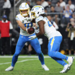 Sep 15, 2025; Paradise, Nevada, USA; Los Angeles Chargers quarterback Justin Herbert (10) hands the ball off to Los Angeles Chargers running back Najee Harris (22) during the second quarter against the Las Vegas Raiders at Allegiant Stadium. Mandatory Credit: Kiyoshi Mio-Imagn Images