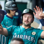 Sep 16, 2025; Kansas City, Missouri, USA; Seattle Mariners catcher Cal Raleigh (29) is congratulated by teammates after hitting a home run in the first inning against the Kansas City Royals at Kauffman Stadium. Mandatory Credit: Scott Sewell-Imagn Images