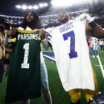 Sep 28, 2025; Arlington, Texas, USA; Green Bay Packers defensive end Micah Parsons (1) and Dallas Cowboys cornerback Trevon Diggs (7) exchange jerseys after the game at AT&T Stadium. Mandatory Credit: Kevin Jairaj-Imagn Images