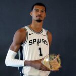 Sep 29, 2025; San Antonio, TX, USA; San Antonio Spurs forward-center Victor Wembanyama (1) holds his Fan Favorite award for Defensive Player of the Year during Media Day at Victory Capital Performance Center in San Antonio.