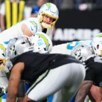 Jan 5, 2025; Paradise, Nevada, USA; Los Angeles Chargers quarterback Justin Herbert (10) looks to snap the ball against the Las Vegas Raiders during the fourth quarter at Allegiant Stadium.