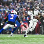 Jan 19, 2025; Orchard Park, New York, USA; Baltimore Ravens quarterback Lamar Jackson (8) runs the ball against Buffalo Bills safety Damar Hamlin (3) during the fourth quarter in a 2025 AFC divisional round game at Highmark Stadium.