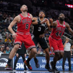 Dec 8, 2023; San Antonio, Texas, USA; Chicago Bulls center Nikola Vucevic (9) and forward Patrick Williams (44) block out San Antonio Spurs forward Keldon Johnson (3) in the second half at the Frost Bank Center. Mandatory Credit: Daniel Dunn-USA TODAY Sports
