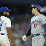 Los Angeles Dodgers Toronto Blue Jays World Series Apr 27, 2024; Toronto, Ontario, CAN; Toronto Blue Jays first baseman Vladimir Guerrero Jr. (27) talks to Los Angeles Dodgers designated hitter Shohei Ohtani (17) after reaching base on a throwing error during the seventh inning at Rogers Centre. Mandatory Credit: John E. Sokolowski-USA TODAY Sports