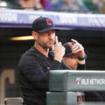 May 28, 2024; Denver, Colorado, USA; Cleveland Guardians bench coach Craig Albernaz (55) calls in a play in the first inning against the Colorado Rockies at Coors Field. Mandatory Credit: Ron Chenoy-USA TODAY Sports