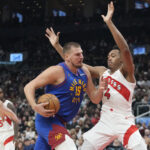 Oct 28, 2024; Toronto, Ontario, CAN; NBA; Denver Nuggets center Nikola Jokic (15) drives to the net against Toronto Raptors forward Scottie Barnes (4) during the first half at Scotiabank Arena.