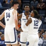Oct 30, 2024; Memphis, Tennessee, USA; Memphis Grizzlies guard Ja Morant (12) talks with center Zach Edey (14) and forward Jaren Jackson Jr. (13) during the first half against the Brooklyn Nets at FedExForum.
