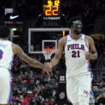 Dec 30, 2024; Portland, Oregon, USA; Philadelphia 76ers center Joel Embiid (21) and forward Paul George (8) high five during the second half against the Portland Trail Blazers at Moda Center.