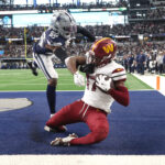 Jan 5, 2025; Arlington, Texas, USA; Washington Commanders wide receiver Terry McLaurin (17) catches the game winning touchdown against Dallas Cowboys cornerback DaRon Bland (26) during the fourth quarter at AT&T Stadium.