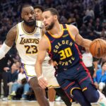 Jan 25, 2025; San Francisco, California, USA; Golden State Warriors guard Stephen Curry (30) dribbles against Los Angeles Lakers forward LeBron James (23) during the third quarter at Chase Center.