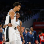 Feb 10, 2025; Washington, District of Columbia, USA; San Antonio Spurs center Victor Wembanyama (1) and guard De'Aaron Fox (4) react during the second quarter against the Washington Wizards at Capital One Arena.
