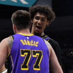 Feb 22, 2025; Denver, Colorado, USA; Los Angeles Lakers guard Luka Doncic (77) is congratulated by center Jaxson Hayes (11) after making a basket during the second half against the Denver Nuggets at Ball Arena.