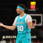 Mar 12, 2025; Atlanta, Georgia, USA; Charlotte Hornets guard Seth Curry (30) reacts to foul Atlanta Hawks guard Trae Young (11) during the first quarter at State Farm Arena. Mandatory Credit: Mady Mertens-Imagn Images