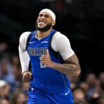Mar 31, 2025; Dallas, Texas, USA; Dallas Mavericks center Daniel Gafford (21) grimaces as he runs back up the court during the second half against the Brooklyn Nets at the American Airlines Center.