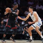 Apr 3, 2025; NBA; Miami, Florida, USA; Miami Heat center Bam Adebayo (13) protects the basketball from Memphis Grizzlies forward Santi Aldama (7) during the first quarter at Kaseya Center.