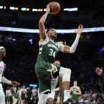 Apr 5, 2025; Miami, Florida, USA; Milwaukee Bucks forward Giannis Antetokounmpo (34) goes up for a dunk in overtime as Miami Heat center Bam Adebayo (13) follows on the play at Kaseya Center. Mandatory Credit: Jim Rassol-Imagn Images