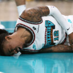 Apr 24, 2025; Memphis, Tennessee, USA; Memphis Grizzlies guard Ja Morant (12) lays on the court after being fouled during the second quarter against the Oklahoma City Thunder during game three for the first round of the 2024 NBA Playoffs at FedExForum.