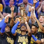 Jun 22, 2025; Oklahoma City, Oklahoma, USA; Oklahoma City Thunder guard Shai Gilgeous-Alexander (2) holds up his NBA Finals Bill Russell MVP trophy at the end of game seven of the 2025 NBA Finals after defeating the Indiana Pacers at Paycom Center.