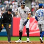 Sep 7, 2025; Bronx, New York, USA; New York Yankees right fielder Aaron Judge (99) reacts after stealing a base against Toronto Blue Jays third baseman Ernie Clement (22) at Yankee Stadium. Mandatory Credit: Mark Smith-Imagn Images