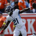 Sep 7, 2025; Denver, Colorado, USA; Tennessee Titans cornerback Roger McCreary (21) reacts after an interception against the Denver Broncos in the first half at Empower Field at Mile High. Mandatory Credit: Isaiah J. Downing-Imagn Images