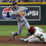 MLB Sep 24, 2025; Phoenix, Arizona, USA; Los Angeles Dodgers shortstop Mookie Betts (50) gets the out on Arizona Diamondbacks second base Ketel Marte (4) in the third inning at Chase Field. Mandatory Credit: Rick Scuteri-Imagn Images