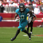 Sep 28, 2025; Santa Clara, California, USA; Jacksonville Jaguars linebacker Devin Lloyd (0) returns an interception against the San Francisco 49ers during the third quarter at Levi's Stadium. Mandatory Credit: Darren Yamashita-Imagn Images