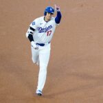 Los Angeles Dodgers designated hitter Shohei Ohtani (17) gestures towards fans after scoring a homer in the first inning of the MLB National League Wild Card Game 1 between the Cincinnati Reds and LA Dodgers, Tuesday, Sept. 30, 2025, at Dodger Stadium in Los Angeles, California.