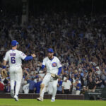 Oct 2, 2025; Chicago, Illinois, USA; Chicago Cubs first baseman Michael Busch (29) and third baseman Matt Shaw (6) celebrate defeating the San Diego Padres during game three of the Wildcard round for the 2025 MLB playoffs at Wrigley Field. Mandatory Credit: David Banks-Imagn Images