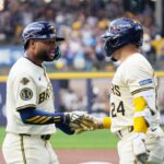 Milwaukee Brewers center fielder Jackson Chourio (11) scores and celebrates with Milwaukee Brewers catcher William Contreras (24) during the first inning of their National League Division Series game against the Chicago Cubs on Saturday October 4, 2025 at American Family Field in Milwaukee, Wisconsin.