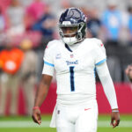 Oct 5, 2025; Glendale, Arizona, USA; Tennessee Titans quarterback Cam Ward (1) warms up on the field before their game against the Arizona Cardinals at State Farm Stadium. Mandatory Credit: Joe Camporeale-Imagn Images