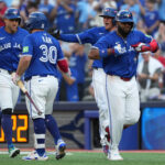 Oct 5, 2025; Toronto, Ontario, CAN; Toronto Blue Jays first baseman Vladimir Guerrero Jr. (27) celebrates with teammates after hitting a grand slam in the fourth inning against the New York Yankees during game two of the ALDS round for the 2025 MLB playoffs at Rogers Centre. Mandatory Credit: Kevin Sousa-Imagn Images
