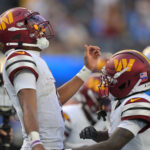 Oct 5, 2025; Inglewood, California, USA; Washington Commanders quarterback Jayden Daniels (5) celebrates after a touchdown against the Los Angeles Chargers in the second half at SoFi Stadium. Mandatory Credit: Jayne Kamin-Oncea-Imagn Images