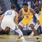 Oct 5, 2025; San Francisco, California, USA; Los Angeles Lakers guard Bronny James (9) defends Golden State Warriors guard Stephen Curry (30) in the first quarter at Chase Center. Mandatory Credit: David Gonzales-Imagn Images