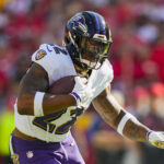 Sep 28, 2025; Kansas City, Missouri, USA; Baltimore Ravens running back Derrick Henry (22) runs the ball during the first half against the Kansas City Chiefs at GEHA Field at Arrowhead Stadium. Mandatory Credit: Jay Biggerstaff-Imagn Images