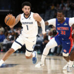 Oct 6, 2025; Memphis, Tennessee, USA; Memphis Grizzlies guard Scotty Pippen Jr. (1) dribbles around a screen set by forward Olivier-Maxence Prosper (18) on Detroit Pistons guard Javonte Green (31) during the fourth quarter at FedExForum.
