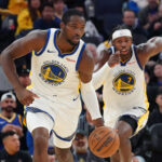 Oct 5, 2025; San Francisco, California, USA; Golden State Warriors forward Jonathan Kuminga (1) dribbles upcourt, as guard Buddy Hield (7) trails, against the Los Angeles Lakers in the third quarter at Chase Center.