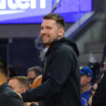 Oct 5, 2025; San Francisco, California, USA; Los Angeles Lakers forward/guard Luka Doncic (77) smiles from the sidelines during the second quarter against the Golden State Warriors at Chase Center. Mandatory Credit: David Gonzales-Imagn Images