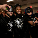 Oct 8, 2025; Bronx, New York, USA; Toronto Blue Jays shortstop Bo Bichette (left to right) and first baseman Vladimir Guerrero Jr. and shortstop Andres Gimenez celebrate in the locker room after defeating the New York Yankees in game four of the ALDS round of the 2025 MLB playoffs at Yankee Stadium. Mandatory Credit: Brad Penner-Imagn Images