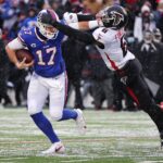 Bills quarterback Josh Allen fights off a tackle by Falcons Donte Fowler Jr.