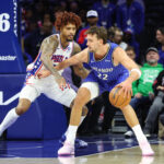 Oct 10, 2025; Philadelphia, Pennsylvania, USA; Orlando Magic forward Franz Wagner (22) controls the ball against Philadelphia 76ers forward/guard Kelly Oubre Jr. (9) during the first quarter at Xfinity Mobile Arena.