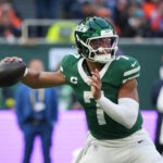 Oct 12, 2025; Tottenham, United Kingdom; New York Jets quarterback Justin Fields (7) throws a pass against the Denver Broncos during an NFL International Series game at Tottenham Hotspur Stadium. Mandatory Credit: Kirby Lee-Imagn Images