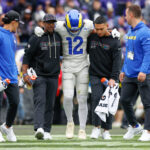 Oct 12, 2025; Baltimore, Maryland, USA; Los Angeles Rams wide receiver Puka Nacua (12) is helped off the field by trainers during the second quarter of the game against the Baltimore Ravens at M&T Bank Stadium. Mandatory Credit: Peter Casey-Imagn Images