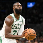 Oct 12, 2025; Boston, Massachusetts, USA; Boston Celtics guard/forward Jaylen Brown (7) attempts a free throw against the Cleveland Cavaliers during the first half at TD Garden.