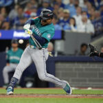 Oct 12, 2025; Toronto, Ontario, CAN; Seattle Mariners second baseman Jorge Polanco (7) hits an RBI single against the Toronto Blue Jays in the eighth inning during game one of the ALCS round for the 2025 MLB playoffs at Rogers Centre. Mandatory Credit: John E. Sokolowski-Imagn Images