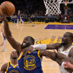 Oct 12, 2025; Los Angeles, California, USA; Golden State Warriors forward Draymond Green (23) and Los Angeles Lakers center Deandre Ayton (5) go for a rebound during the second half at Crypto.com Arena.