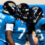 Jacksonville Jaguars wide receiver Brian Thomas Jr. (7) is congratulated by wide receiver Dyami Brown (5) and running back Lequint Allen Jr. (36) on a touchdown that was called back on a offensive penalty during the third quarter of an NFL football matchup, Sunday, Oct. 12, 2025, at EverBank Stadium in Jacksonville, Fla. The Seahawks defeated the Jaguars 20-12.