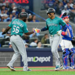 Oct 13, 2025; Toronto, Ontario, CAN; Seattle Mariners infielder Jorge Polanco (7) celebrates a three run home run with outfielder Randy Arozarena (56) in the fifth inning against the Toronto Blue Jays during game two of the ALCS round for the 2025 MLB playoffs at Rogers Centre.