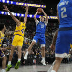 Oct 15, 2025; Las Vegas, Nevada, USA; Dallas Mavericks forward Cooper Flagg (32) shoots the ball against Los Angeles Lakers forward Anton Watson (41) during the first half at T-Mobile Arena. Mandatory Credit: Lucas Peltier-Imagn Images