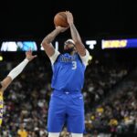 Oct 15, 2025; Las Vegas, Nevada, USA; Dallas Mavericks forward Anthony Davis (3) shoots the ball against Los Angeles Lakers guard R.J. Davis (55) during the first half at T-Mobile Arena.